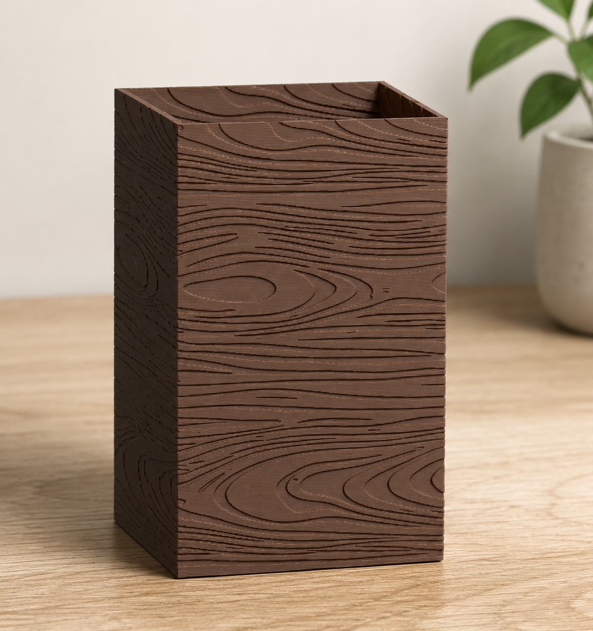 Close-up of a walnut-toned furniture riser with a carved wood grain texture